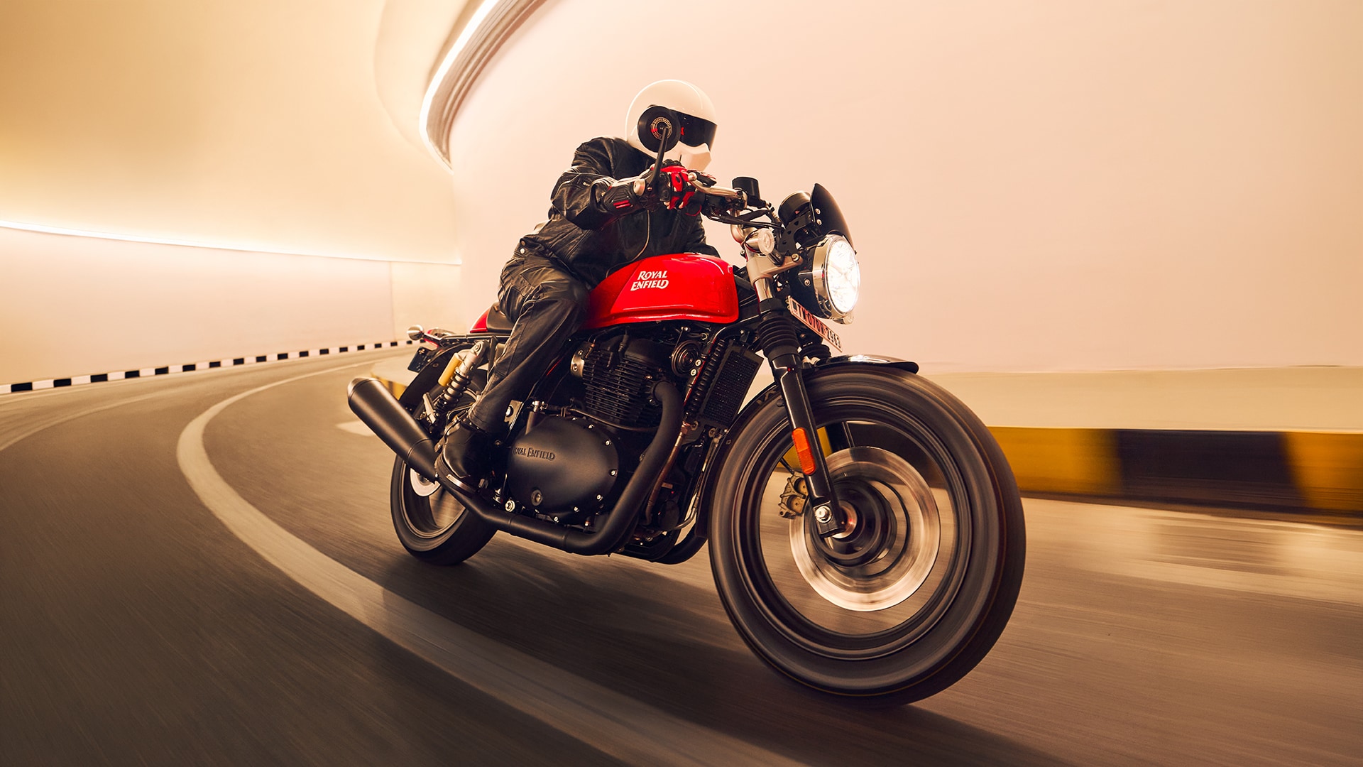 2026 Royal Enfield Continental GT 650 in Rocker Red being ridden through a tunnel